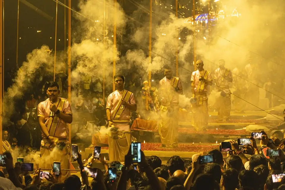 Priests performing the evening Ganga Aarti with lamps and smoke on the ghats of Varanasi